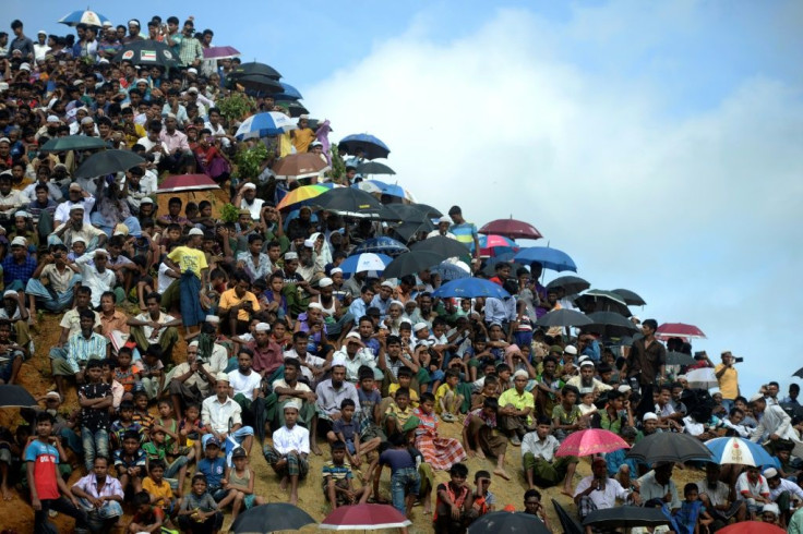 Rohingya refugees attend a ceremony marking the second anniversary of a military crackdown that prompted their exodus from Myanmar. Bangladesh authorities say thousands of refugees have agreed to be moved to an island in the Bay of Bengal
