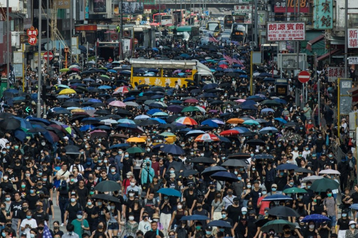 Thousands of people marched through Mong Kok in Hong Kong in defiance of a police ban on the gathering