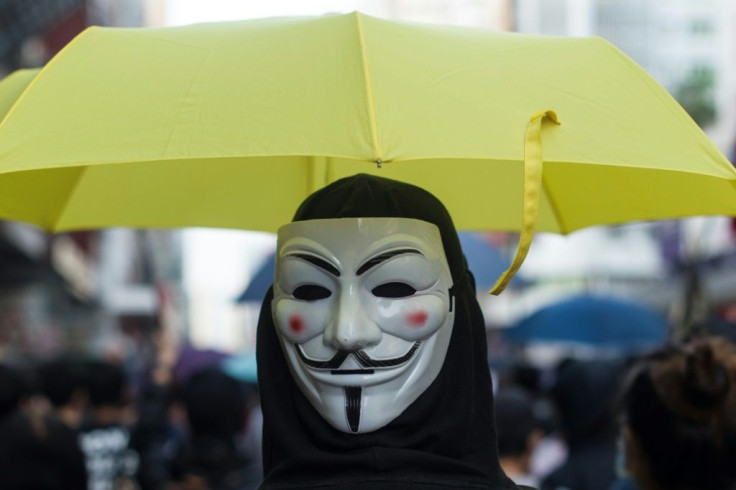 A protester in a Guy Fawkes mask takes part in a pro-democracy march in Hong Kong