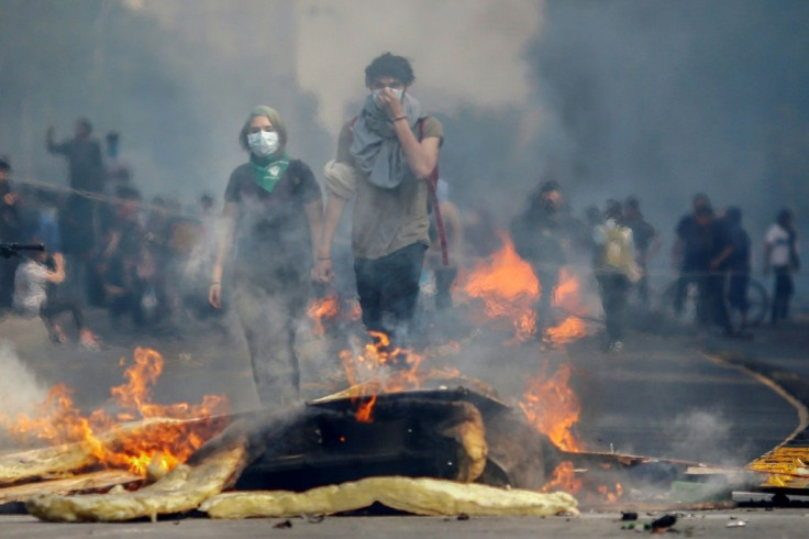 Two days of violent unrest in Santiago have seen metros and buses burned, and clashes between riot police and protesters