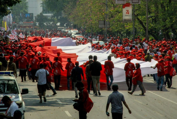 Outside parliament, red-and-white Indonesian flags dotted parts of the city but celebrations were muted under heavy security