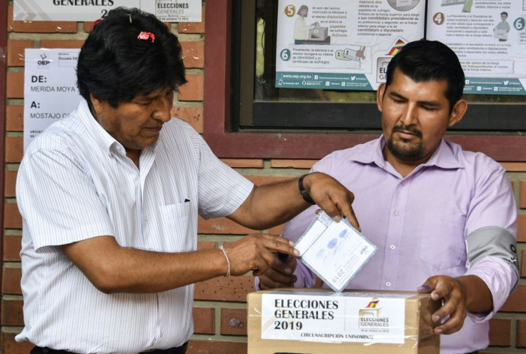 Bolivia's President Evo Morales (L) casts his vote in Chapare in the department of Cochabamba