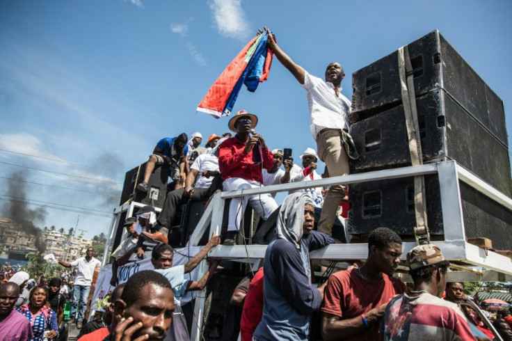 Demonstrators take part in a protest demanding the resignation of President Jovenel Moise in the Haitian capital in Port-au-Prince on October 20, 2019