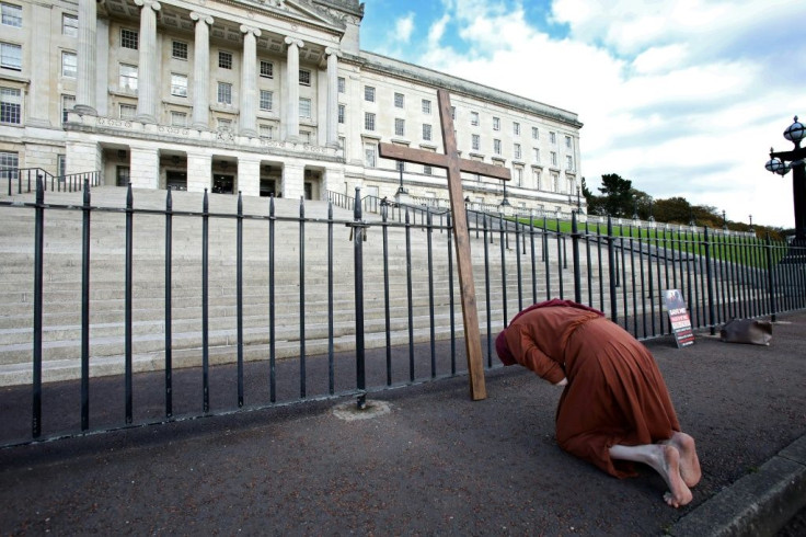 An anti-abortion activist demonstrates outside the pParliament Building in Belfast on Monday