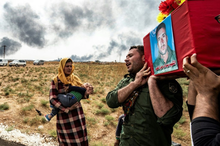 Mourners attend the funeral of civilians and fighters killed during attacks by Turkish-led forces on the border town of Ras al-Ain