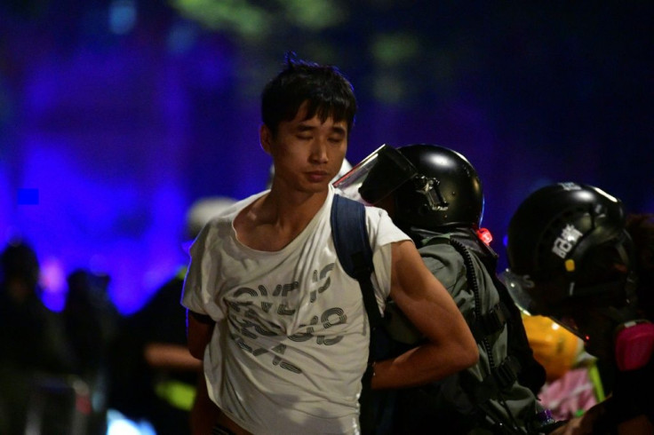 Riot police detain another pro-democracy demonstrator in Hong Kong on Monday