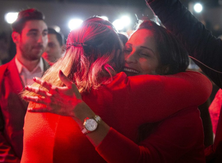 Supporters of Liberal party candidate, Justin Trudeau, react to the announcements of the first election results