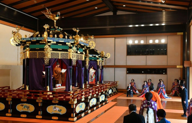 Set in the palace's Pine Room were the two structures housing the thrones, draped with purple curtains that were ceremonially opened to reveal the royal couple standing within