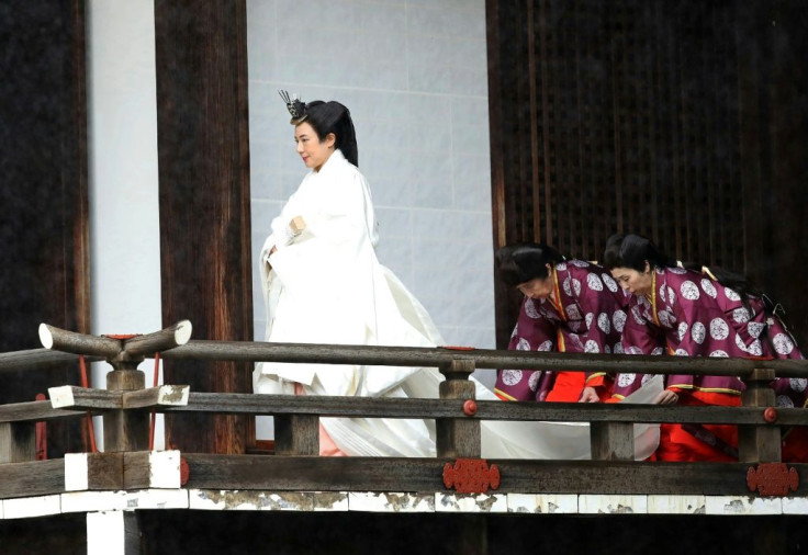 Empress Masako wore a multi-layered kimono, trailed by attendants to help her move in the weighty outfit