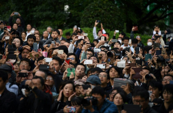 A small crowd of well-wishers gathered outside the palace despite driving rain and the cancellation of a parade