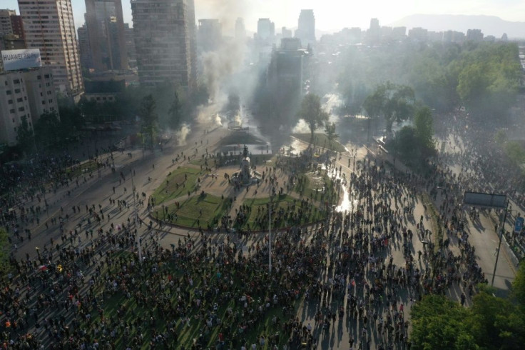 Violent unrest in Santiago has seen metros and buses burned, and clashes between riot police and protesters