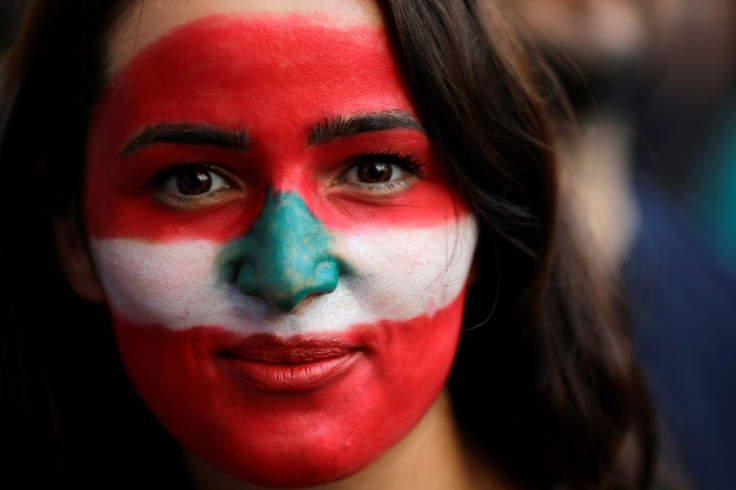 Many protesters have painted their faces in the colours of the national flag