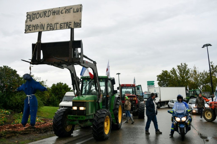 A tractor with a hanged effigy of a farmer under a sign saying "Today it's him, tomorrow it might be me," during a protest by farmers in Nimes, southern France, on Tuesday.