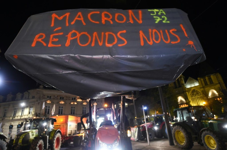 Tractors with a sign saying "Macron, answer us!" as farmers began a protest on Monday in Le Mans, western France.