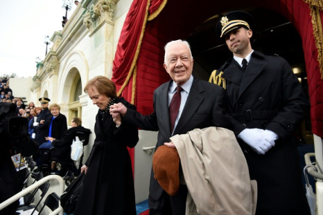 US President Jimmy Carter, who suffered a fall at his home in Plains, Georgia, is pictured here with First Lady Rosalynn Carter arriving at Donald Trump's inauguration January 20, 2017