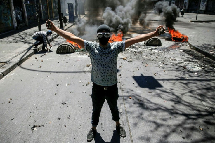 Demonstrators clash against soldiers during a protest in Valparaiso, Chile, on October 21, 2019