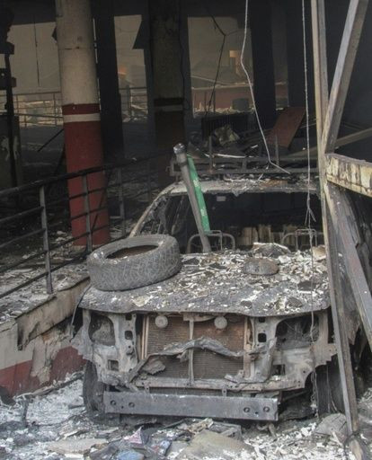 A burned car outside an electoral office in Sucre after rioting in the city on Monday