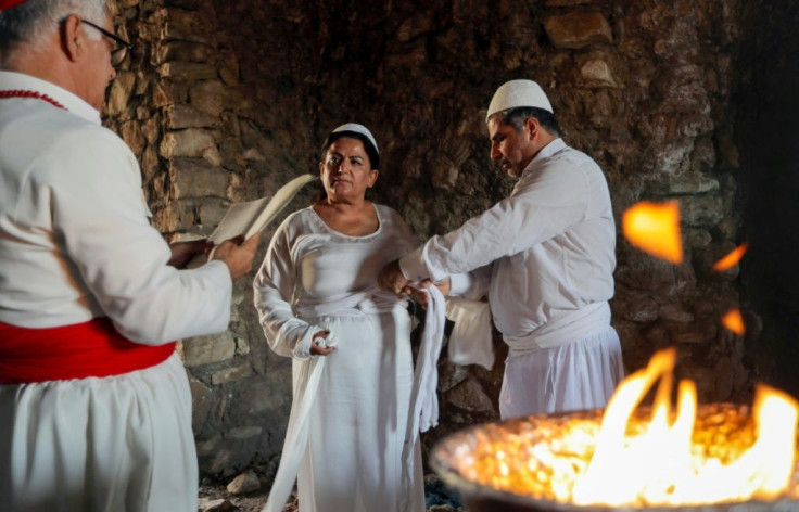 Iraqi Kurd Faiza Fouad takes part in a ritual ceremony in an ancient and ruined temple as she joins the millennia-old Zoroastrian religion