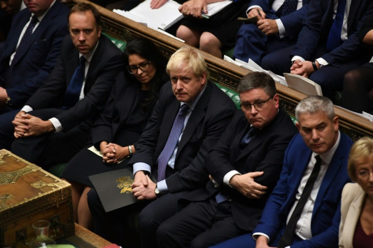 Prime Minister Boris Johnson (C) told lawmakers he would "pause" the ratification process while the EU decides on an extension