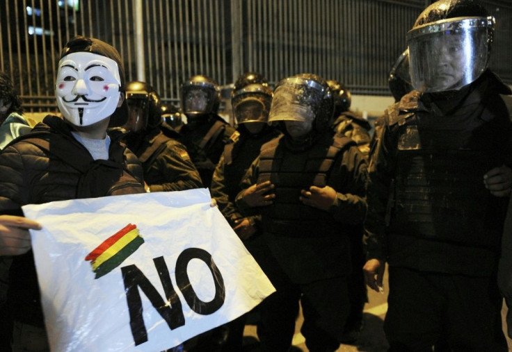 A supporter of Bolivia's presidential candidate Carlos Mesa in front of riot police during a protest over the disputed vote count