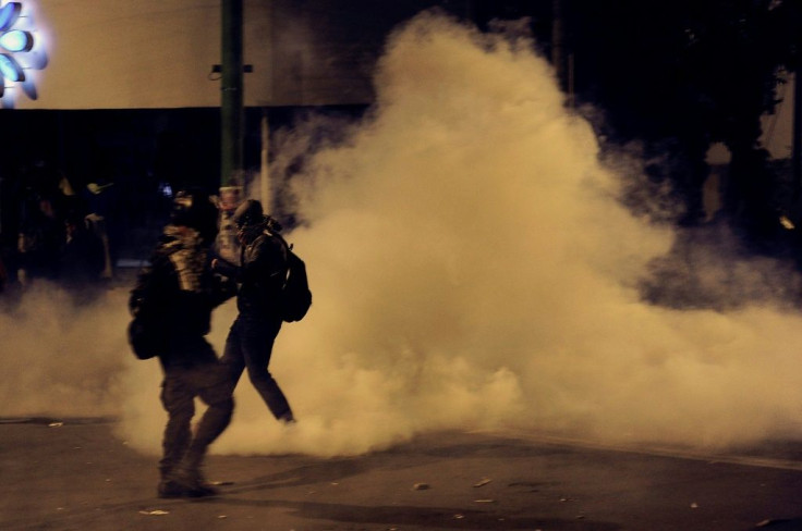 Supporters of Bolivia's presidential candidate Carlos Mesa are dispersed with tear gas by riot police