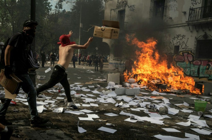 Demonstrators participate in street violence on October 22 in Santiago