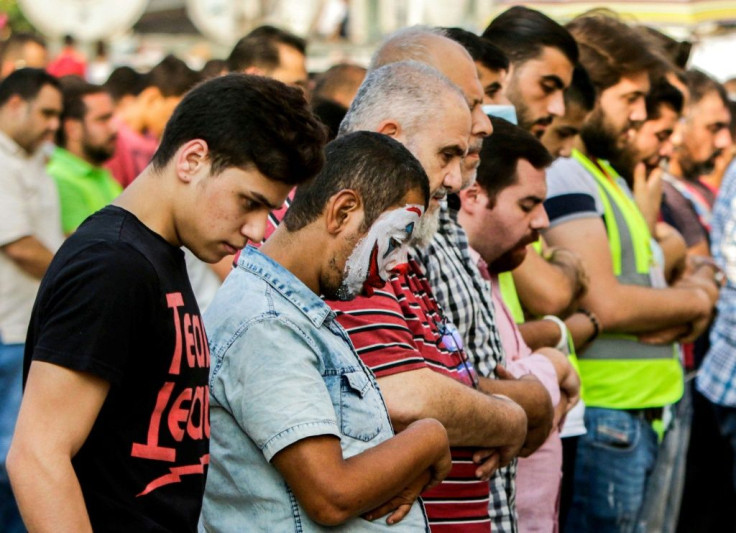 A Tripoli demonstrator in "The Joker" facepaint prays alongside members of Hizb ut-Tahrir, one of the radical Islamist groups that have long dominated public perceptions of Lebanon's second city