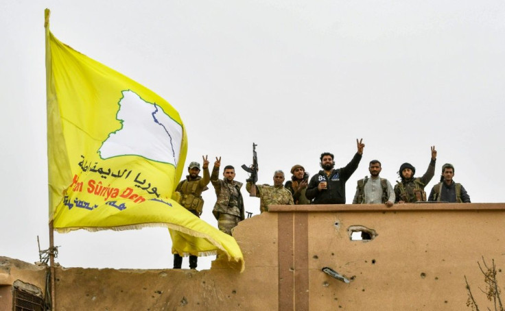 Syrian Kurdish fighters raise their flag in March after overrunning the last vestige of the Islamic Strate group's "caliphate" in a US-backed offensive they had hoped would earn them Western support for their dreams of self-rule