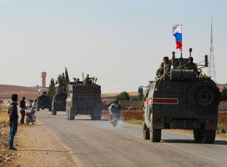 A convoy of Russian military vehicles heads towards the northeastern Syrian city of Kobane