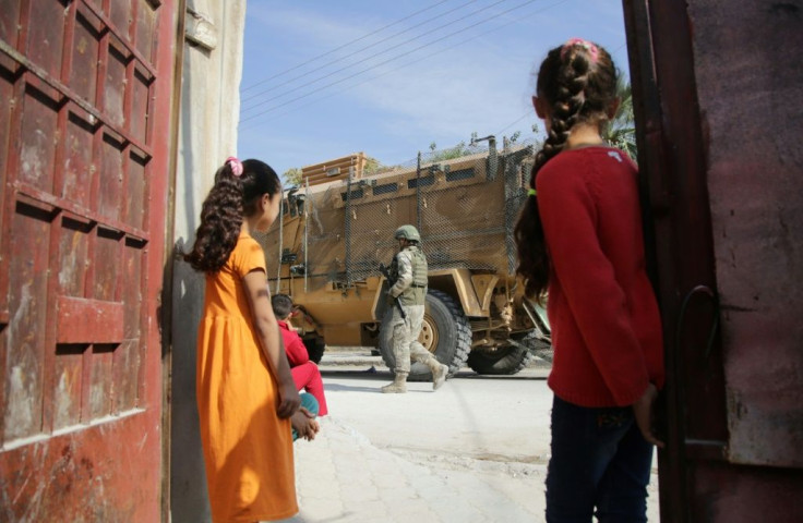 Turkish soldiers patrol the northern Syrian Kurdish town of Tal Abyad near the Turkish border on Wednesday