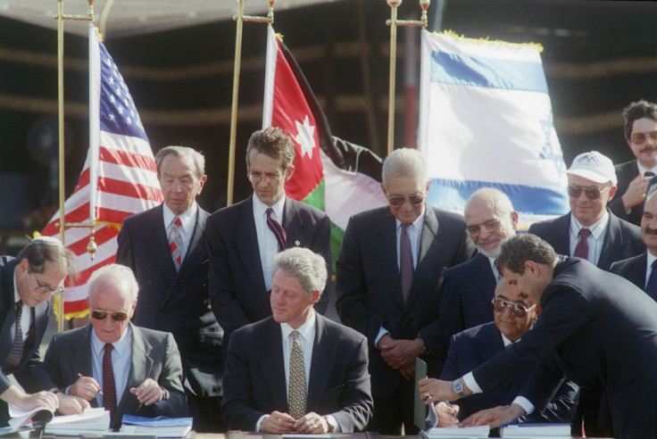 US President Bill Clinton (C) witnesses Israeli Premier Yitzhak Rabin (L) and his Jordanian counterpart Abdelsalam Majali signing the Israeli-Jordanian peace accord at the Wadi Araba border crossing