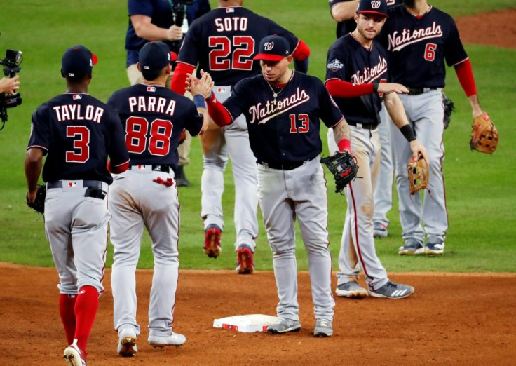 Washington's Asdrubal Cabrera celebrates with his Nationals teammates after their 12-3 win over the Houston Astros in game two of the 2019 World Series