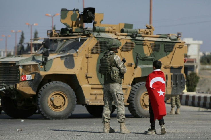 Turkish soldiers patrol the Syrian border town of Tal Abyad, part of an Arab-majority strip along the frontier where Ankara will retain full control under the deal reached with Moscow