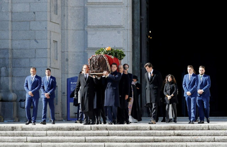 Eight family members carry the coffin of the late Spanish dictator Francisco Franco out of the basilica at the Valley of the Fallen ahead of its transfer to a more discreet burial site