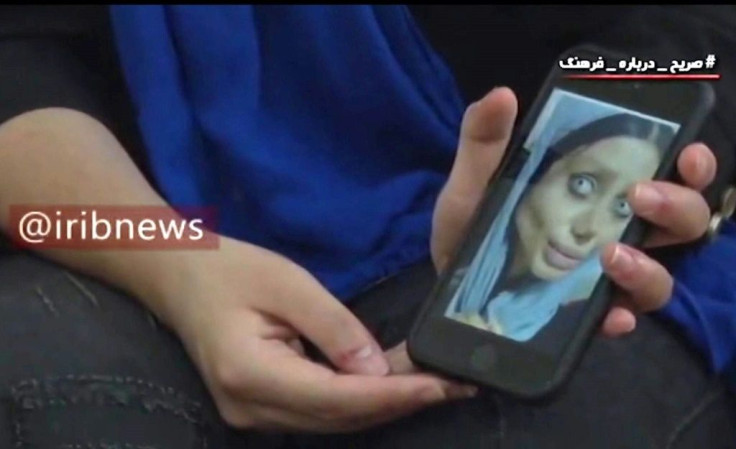 Iranian social media celebrity Sahar Tabar shows state television one of the images of herself she posted on Instagram that landed her behind bars