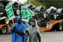 United Auto Workers (UAW) members picket outside of General Motors Detroit-Hamtramck Assembly in Detroit, Michigan, as they strike on October 16, 2019. Leaders of the United Auto Workers union announced October 16, 2019, they have reached a tentative deal