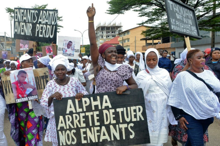 Protestors held up placards reading 'Children shot, Future lost,' and 'Alpha, stop killing our children'