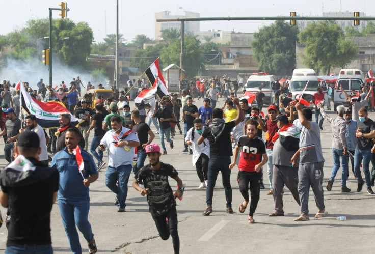 Iraqi security forces use tear gas to disperse the crowds in Baghdad as thousands of protesters massed near the high-security Green Zone in the second phase of a wave of anti-government demos