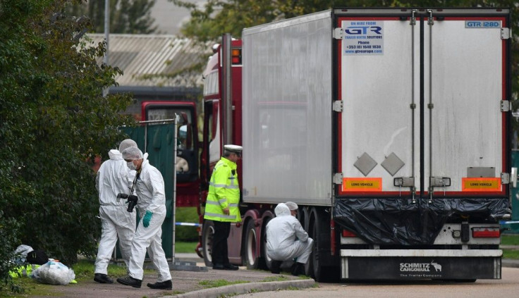 British Police forensics officers work on lorry, found to be containing 39 dead bodies, at Waterglade Industrial Park in Grays, east of LondonindusTrial park in Grays, east of London