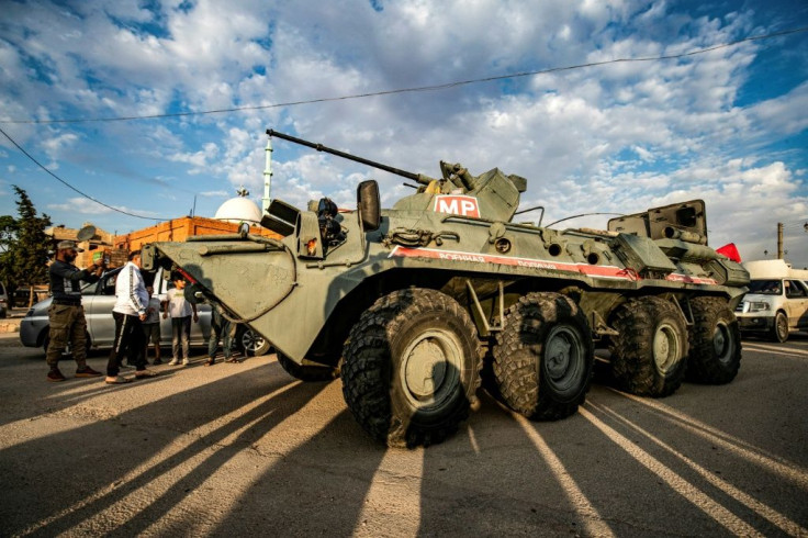 A Russian military police armoured vehicle passes through the northeastern Syrian town of Amuda in Hasakeh province on a joint patrol with Kurdish security forces
