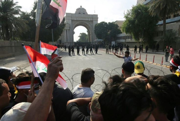 Iraqi security forces bar the route to protestors trying to reach the Green Zone, which hosts government offices and foreign embassies