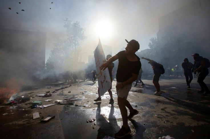 Demonstrators clash with riot police in Santiago on October 24, 2019