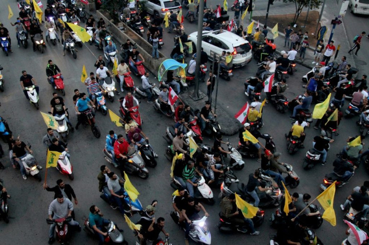 Supporters of the Shiite Hezbollah movement drive in a convoy in support of its leader Hassan Nasrallah's speech, in the southern suburbs of Beirut on October 25, 2019.Tensions rattled Lebanon's nine-day protest movement today, with a powerful Shiite lead