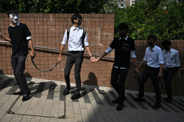 High school students take part in a human chain rally outside Kowloon park in Hong Kong on October 25, 2019.Hong Kong has been battered by more than four months of sometimes violent unrest that have battered the economy, sparked by a now-shelved bill allo