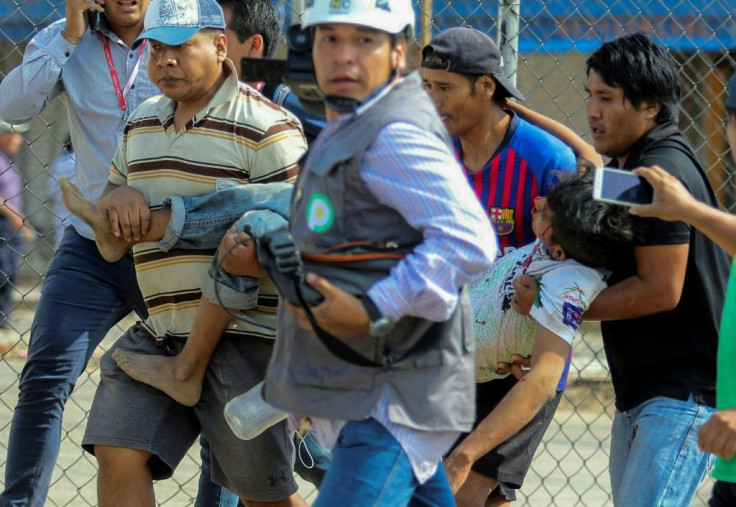 A supporter of Mesa is assisted after being wounded during clashes with Morales backers