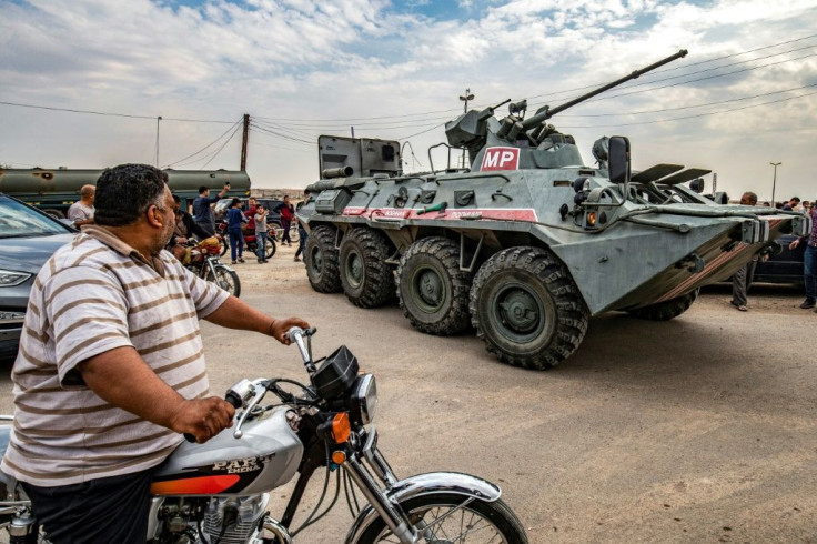 Russian military police patrol along the Syria-Turkey border