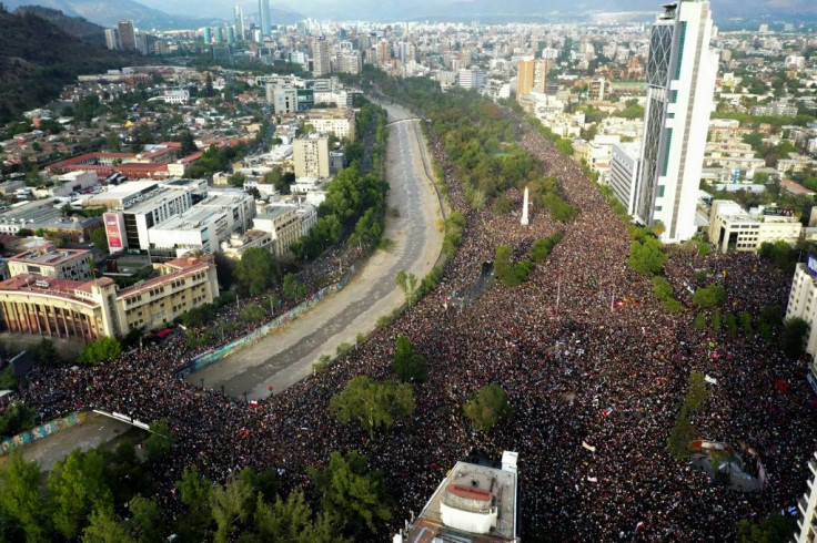 People protest in Santiago on October 25, a week after violence protests started