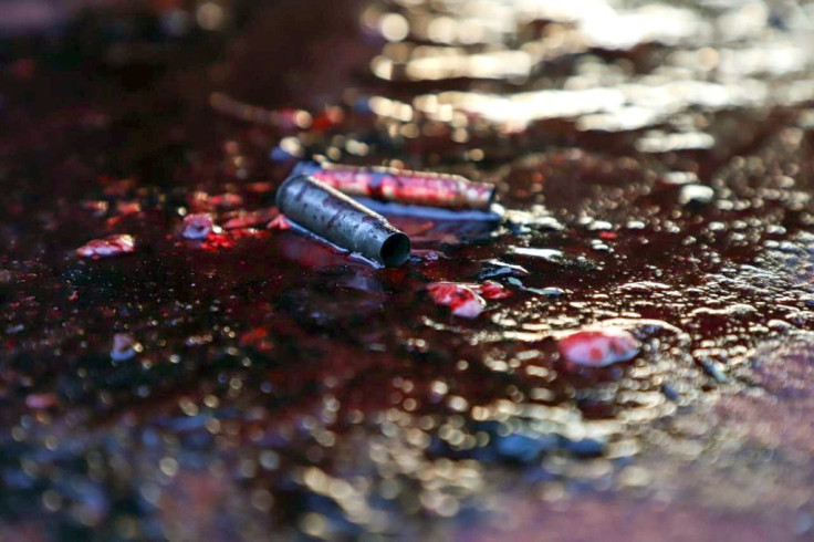 Ammunition shells lay on a pool of blood in a street of Culiacan