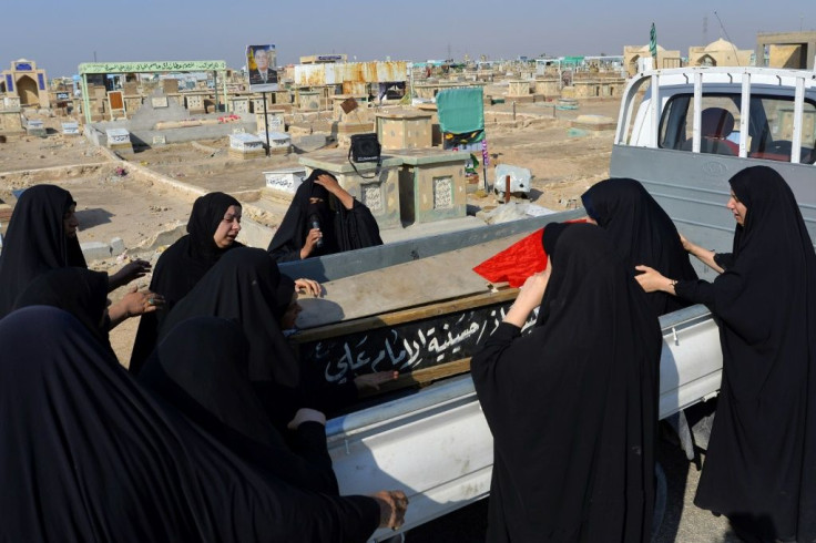Iraqi women mourn for a demonstrator who was killed the previous day in anti-government protests in during his funeral