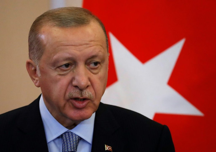 Turkish President Recep Tayyip Erdogan says he will "clear terrorists" from the border between Turkey and northern Syria if Syrian Kurdish militia don't withdraw by Tuesday